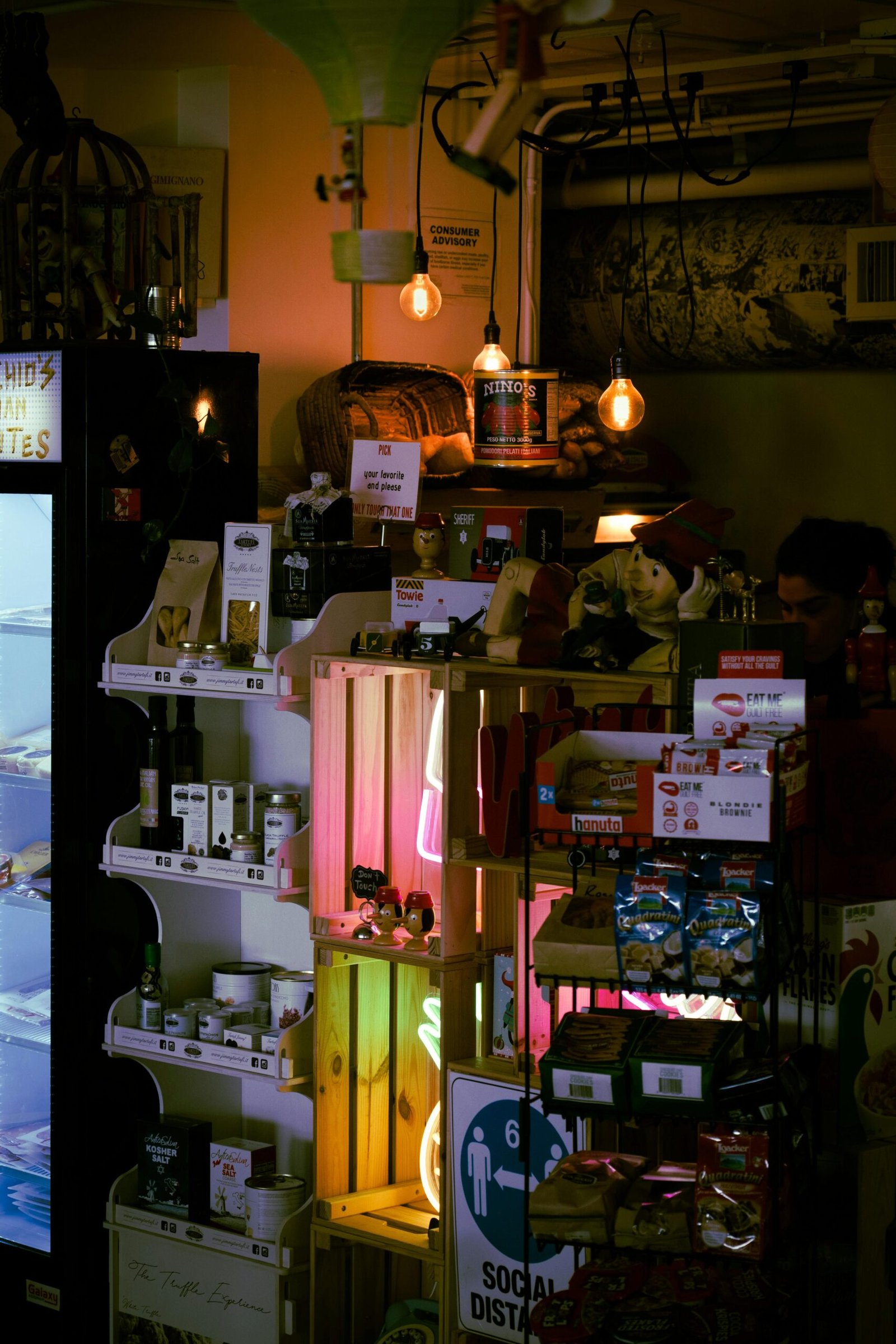 Warm and inviting general store interior, featuring stocked shelves and social distancing sign.